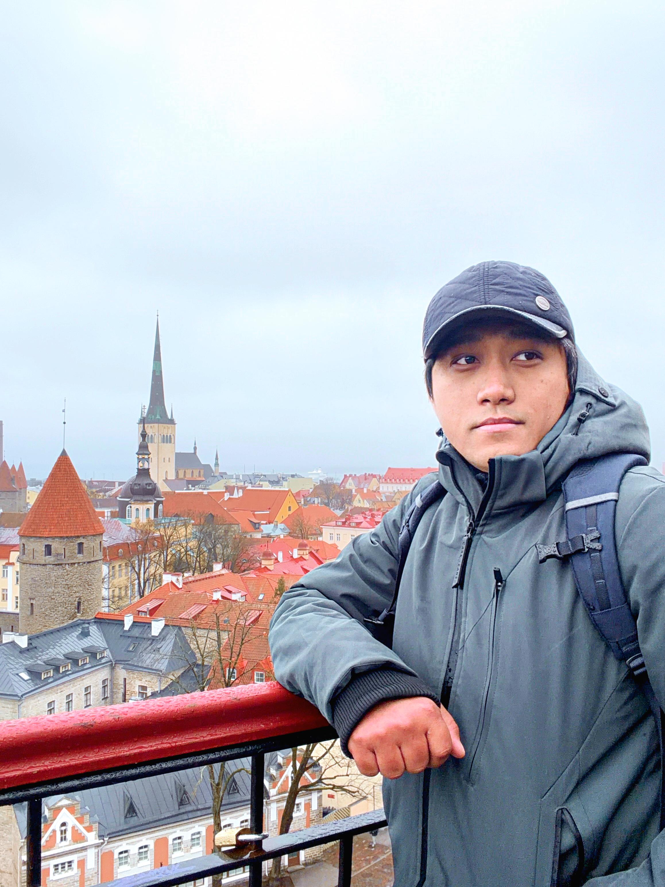 Mark A. Basco overlooking a city of red rooftops